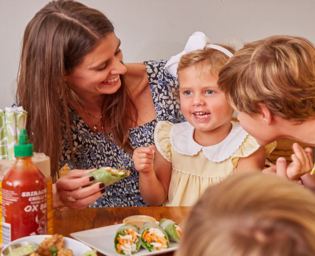 Mother with her children eating rolls